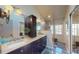 Elegant bathroom featuring a double vanity, modern lighting, and a glass-enclosed shower at 64 Pelican Pl, Belleair, FL 33756