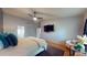 Spacious bedroom with a ceiling fan, TV, and hardwood floors at 64 Pelican Pl, Belleair, FL 33756