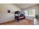 Cozy bedroom featuring carpeted floors, a window with blinds, and a bunk bed for flexible sleeping arrangements at 64 Pelican Pl, Belleair, FL 33756
