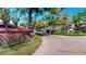 Serene street view of Pelican Place featuring lush landscaping and well-maintained homes at 64 Pelican Pl, Belleair, FL 33756