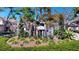 Sculptural pelican sign for the Pelican Place community surrounded by lush landscaping on a sunny day at 64 Pelican Pl, Belleair, FL 33756
