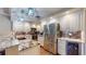 Modern kitchen features stainless steel appliances, granite counters and stylish lighting at 64 Pelican Pl, Belleair, FL 33756