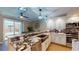 Updated kitchen with granite counters, stainless sink, modern lighting, and stainless steel appliances at 64 Pelican Pl, Belleair, FL 33756