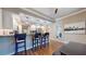 Bright kitchen with granite countertop bar with seating and stainless appliances in an open layout at 64 Pelican Pl, Belleair, FL 33756
