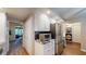 Well-equipped kitchen with stainless steel appliances, white cabinetry, and a breakfast nook with a view at 64 Pelican Pl, Belleair, FL 33756
