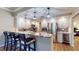 Modern kitchen features bar-style seating, stainless steel appliances, granite counters and stylish pendant lighting at 64 Pelican Pl, Belleair, FL 33756