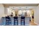 Modern kitchen features bar seating, granite countertops, stainless steel appliances, and stylish pendant lighting at 64 Pelican Pl, Belleair, FL 33756