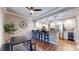 Modern kitchen with stainless steel appliances, granite countertops, breakfast bar, and stylish pendant lighting at 64 Pelican Pl, Belleair, FL 33756