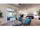 Inviting living room with a fireplace, comfortable seating, and sliding glass doors to the outdoor patio at 64 Pelican Pl, Belleair, FL 33756