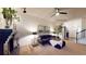 Bright living room with black brick fireplace, neutral carpet and modern furniture at 64 Pelican Pl, Belleair, FL 33756