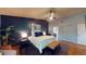 Beautiful main bedroom with dark accent wall, ceiling fan, and access to main bathroom and closet at 64 Pelican Pl, Belleair, FL 33756