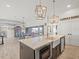 Kitchen island with white countertops in an open-concept area with stainless steel appliances at 6421 4Th Palm Pt, St Pete Beach, FL 33706