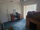 Bedroom featuring vintage roll top desk, computer desk, and large window at 6473 Blackbird Ave, Weeki Wachee, FL 34613