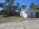 Front lawn and side of house with mature trees at 6473 Blackbird Ave, Weeki Wachee, FL 34613