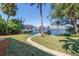 Lush backyard featuring manicured lawn and private dock with boat lift, perfect for waterfront enjoyment at 6804 Sea Gull S Dr, St Petersburg, FL 33707