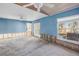 Spacious bedroom featuring two ceiling fans, blue walls, and double doors to the backyard at 6804 Sea Gull S Dr, St Petersburg, FL 33707