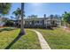 Well-kept home with a stone walkway, green lawn, and professional landscaping at 6804 Sea Gull S Dr, St Petersburg, FL 33707