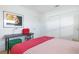 Bright bedroom with a sleek desk, ample storage, and a cozy bed, set on light hardwood flooring at 715 44Th Ne Ave, St Petersburg, FL 33703