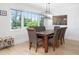 Light filled dining area with modern chandelier, large picture window and decorative sunflower painting at 715 44Th Ne Ave, St Petersburg, FL 33703