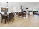 Bright kitchen with modern appliances, barstool seating, and an open dining area with decorative sunflower painting at 715 44Th Ne Ave, St Petersburg, FL 33703