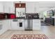 Updated kitchen with stainless appliances, wood backsplash, and stainless steel sink with modern finishes at 715 44Th Ne Ave, St Petersburg, FL 33703
