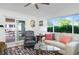 Comfortable living room with a glass table, sliding glass door, and ample natural light from surrounding windows at 715 44Th Ne Ave, St Petersburg, FL 33703
