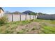 Large backyard featuring a swing set, surrounded by a secure fence and greenery at 7233 Lumber Port Dr, Ruskin, FL 33573