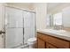 Bathroom featuring a step-in shower with glass door, vanity and sink at 7233 Lumber Port Dr, Ruskin, FL 33573