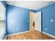 The bedroom features wood-look laminate flooring and an ensuite bathroom at 7233 Lumber Port Dr, Ruskin, FL 33573