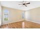 A light and airy bedroom with light yellow walls, wood laminate floors and natural light at 7233 Lumber Port Dr, Ruskin, FL 33573