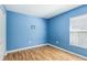Bright and airy bedroom with vinyl floors and a view to the outside at 7233 Lumber Port Dr, Ruskin, FL 33573