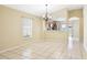 Open-concept dining area with tile floors and a view into the kitchen at 7233 Lumber Port Dr, Ruskin, FL 33573
