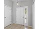 Inviting entryway features tiled flooring, a front door with sidelight, and a neutral color palette at 7233 Lumber Port Dr, Ruskin, FL 33573
