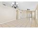 Open floor plan living room with tile floors and a chandelier hanging from the ceiling at 7233 Lumber Port Dr, Ruskin, FL 33573