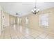 Open living area with tile flooring, windows, and stylish ceiling fans and lights at 7233 Lumber Port Dr, Ruskin, FL 33573