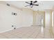 Bright living room with tile flooring, ceiling fan, and neutral-colored walls at 7233 Lumber Port Dr, Ruskin, FL 33573
