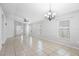 Open-concept living room with neutral walls, tiled floors, a ceiling fan, and natural light through the windows at 7233 Lumber Port Dr, Ruskin, FL 33573