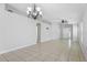 Bright living room with tiled floor, neutral walls, an elegant chandelier, and an open layout at 7233 Lumber Port Dr, Ruskin, FL 33573