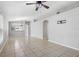 Bright living room with tiled floors, a ceiling fan, and an open layout to the kitchen at 7233 Lumber Port Dr, Ruskin, FL 33573