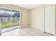 A spacious living room is shown with sliding glass door to the back yard and closet space at 7233 Lumber Port Dr, Ruskin, FL 33573