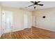 The main bedroom features wood-look laminate flooring, ceiling fan, and ensuite bath at 7233 Lumber Port Dr, Ruskin, FL 33573