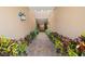 Inviting walkway to home with lush landscaping and beautiful sconce lighting at 7244 Hamilton Rd # 7244, Bradenton, FL 34209