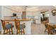 Open kitchen leading into breakfast nook featuring barstool seating, tile floor, and classic details at 8241 73Rd N Ct, Pinellas Park, FL 33781