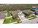 An aerial view of a home showcasing its well-manicured lawn, landscaping, fenced yard and proximity to wooded areas at 8766 Shadyside Ln, Land O Lakes, FL 34637