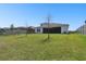 Expansive backyard with lush lawn, play set, and a view of the home at 8766 Shadyside Ln, Land O Lakes, FL 34637