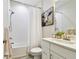 Bright bathroom featuring tub/shower combo, white vanity, and framed artwork at 8766 Shadyside Ln, Land O Lakes, FL 34637