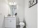 Bathroom featuring a vanity with a large mirror and a toilet at 8766 Shadyside Ln, Land O Lakes, FL 34637
