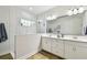 Bright bathroom featuring a double vanity, white subway tile shower, and modern finishes at 8766 Shadyside Ln, Land O Lakes, FL 34637