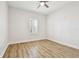 Neutral bedroom with wood-look floors, white trim, and natural light at 8766 Shadyside Ln, Land O Lakes, FL 34637