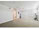 Spacious bonus room with neutral carpet, plantation shutters, exercise equipment, and adjacent bathroom at 8766 Shadyside Ln, Land O Lakes, FL 34637
